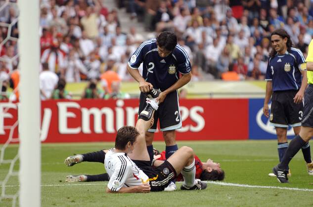 Roberto Ayala (Mitte, Argentinien) hilft Miroslav Klose (Deutschland) nach dem Zusammenprall mit Torwart Roberto Abbondanzieri (Argentinien) die Wade zu lockern, der Keeper liegt mit Schmerzen am Boden Fußball Herren WM 2006, Länderspiel, Nationalteam, Nationaltrikot, Deutschland - Argentinien 4:2 n.E., Vdig Gruppe Berlin Kameradschaft, Fußball Herren WM 2006, Länderspiel, Nationalteam, Nationaltrikot, Deutschland - Argentinien 4:2 n.E., Vdig Gruppe Berlin Kameradschaft,