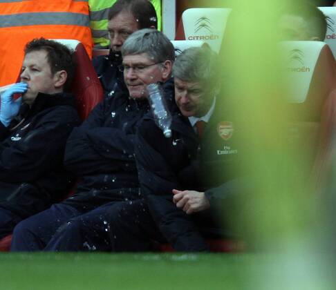 Arsenal FC London - Tottenham Hotspur - Arsenal coach Arsene Wenger (R) loses his temper with a water bottle.