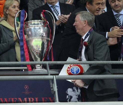 Manchester Uniteds Sir Alex Ferguson goes past the trophy UEFA Champions League Final Manchester United v Barcelona 28th May, 2011 EDITORIAL USE ONLY. No use with unauthorised audio, video, data, fixture lists, club league logos or live services. Online in-match use limited to 120 images, no video emulation. No use in betting, games or single club league player publications.
