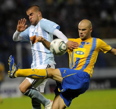 Apoel Nicosia player Paolo Gomes, right, challenges Filip Sebo, left, of Slovan Bratislava during their Champions League 3rd qualifying round, second leg match in Bratislava, Slovakia, Wednesday, Aug. 3, 2011. (CTKxPhoto JanxKoller)  CTKPhoto100201108030980601
