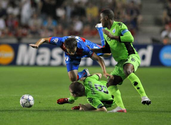 Marek Bakos of FC Viktoria Plzen, left, and Christian Grindheim of FC Copenhagen (on the ground) together with Mathias Jorgensen fighting for the ball during their second leg play-off Champions League soccer match in Prague, Czech Republic, Wednesday, Aug. 24, 2011. (CTKxPhoto RomanxVondrous)  CTKPhoto736201108240940501
