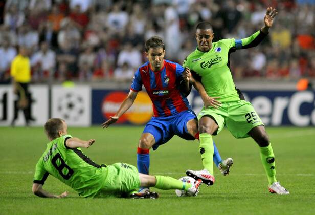 Marek Bakos of FC Viktoria Plzen, left, and Christian Grindheim of FC Copenhagen (on the ground) together with Mathias Jorgensen fighting for the ball during their second leg play-off Champions League soccer match in Prague, Czech Republic, Wednesday, Aug. 24, 2011. (CTKxPhoto RomanxVondrous)  CTKPhoto737201108240942801