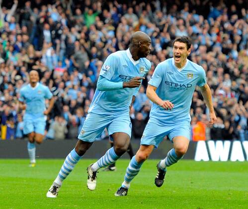 Mario Balotelli of Manchester City turns to celebrate his goal along with Gareth Barry of Manchester City Barclays Premier League Manchester City v Everton 24th September, 2011 EDITORIAL USE ONLY. No use with unauthorised audio, video, data, fixture lists, club league logos or live services. Online in-match use limited to 120 images, no video emulation. No use in betting, games or single club league player publications.