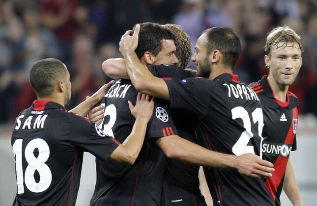 Leverkusen s Michael BALLACK (M) celebrates scoring the 2:0 with teammates Ömer Toprak (R) and Sidney Sam during the Championsleague match between Bayer 04 Leverkusen and KRC Genk, Bayarena in Leverkusen on September 28., 2011. Bayer 04 Leverkusen gegen KRC Genk am 2. Spieltag der Championsleague in der Saison 2011 2012 am 28. September 2011.