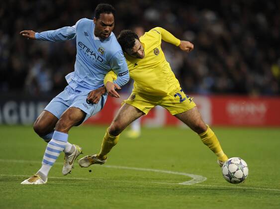 Joleen Lescott of Manchester City tussles with Giuseppe Rossi of Villarreal UEFA Champions League Group A Manchester City v Villarreal 18th October, 2011 EDITORIAL USE ONLY. No use with unauthorised audio, video, data, fixture lists, club league logos or live services. Online in-match use limited to 120 images, no video emulation. No use in betting, games or single club league player publications.