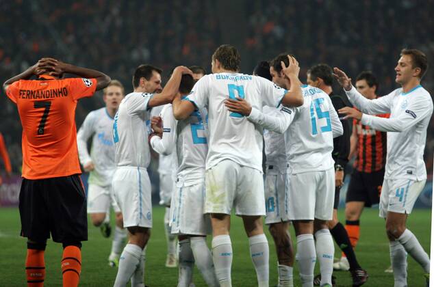 ITAR-TASS: DONETSK, UKRAINE. OCTOBER 20, 2011. Zenitâ€™s players (white) congratulate each other on scoring in a UEFA Champions League Group G match against Shakhtar Donetsk at Donbass Arena Stadium. The game ended in a 2:2 draw.  RE0F062C