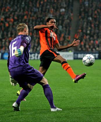 ITAR-TASS: DONETSK, UKRAINE. OCTOBER 20, 2011. Zenitâ€™s goalkeeper Vyacheslav Malafeev and Shakhtarâ€™s Fernandinho (L-R) seen in their UEFA Champions League Group G match at Donbass Arena Stadium. The game ended in a 2:2 draw.  RE0F062D