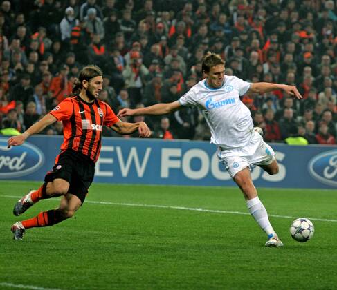 ITAR-TASS: DONETSK, UKRAINE. OCTOBER 20, 2011. Shakhtarâ€™s Dmytro Chygrynskyy and Zenitâ€™s Alexander Bukharov (L-R) fight for a ball in their UEFA Champions League Group G match at Donbass Arena Stadium. The game ended in a 2:2 draw.  RE0F062F