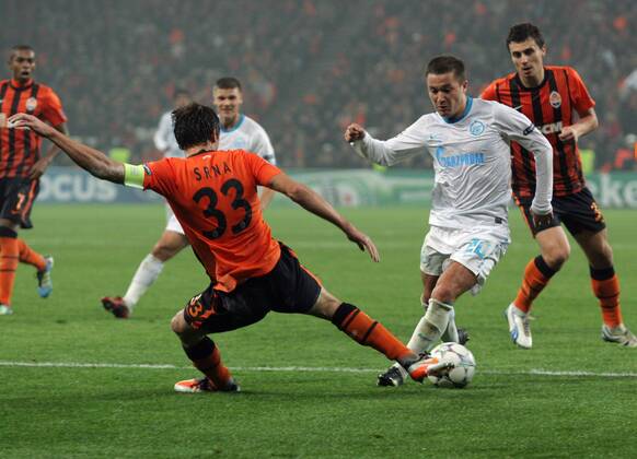 ITAR-TASS: DONETSK, UKRAINE. OCTOBER 20, 2011. Shakhtarâ€™s Darijo Srna (L front), Oleksandr Chyzhov (R background) and Zenitâ€™s Viktor Faizulin (R front) seen in their UEFA Champions League Group G match at Donbass Arena Stadium. The game ended in a 2:2 draw.  RE0F0633