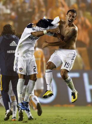 Los Angeles Galaxy s Juninho (19) and A.J. DeLaGarza, left, celebrate their win over the Houston Dynamo in the MLS Fussball Herren USA Cup at the Home Depot Center in Carson, California on Nov. 20, 2011. The Galaxy won 1-0.  LAP20111120917