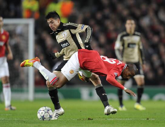 Ashley Young of Manchester United tackled by Ezequiel Garay of SL Benfica UEFA Champions League Group C, Manchester United (ManU) vs Benfica SL Lisbon. 22nd November, 2011 EDITORIAL USE ONLY. No use with unauthorised audio, video, data, fixture lists, club league logos or live services. Online in-match use limited to 120 images, no video emulation. No use in betting, games or single club league player publications.
