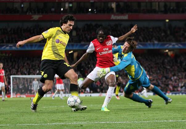 Arsenals Gervinho tussles with Dortmunds Mats Hummels and Roman Weidenfeller UEFA Champions League Group F Arsenal v Borussia Dortmund 23rd November, 2011 EDITORIAL USE ONLY. No use with unauthorised audio, video, data, fixture lists, club league logos or live services. Online in-match use limited to 120 images, no video emulation. No use in betting, games or single club league player publications.