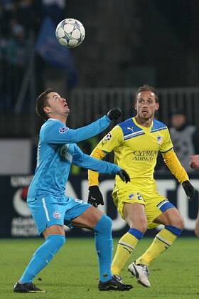 November 23, 2011. - Russia, Saint Petersburg. - Champions League 2011 12 FC Zenit (Saint Petersburg) vs FC APOEL (Cyprus). In picture: FC Zenit s player Viktor Faizulin (20) and FC APOEL s player Nektarios Alexandrou (29). PeterxKovalev 