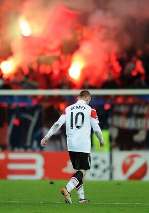 Football - Champions League - FC Basel vs. Manchester United Wayne Rooney of Manchester United looks dejected as he walks from the pitch in front of jubilant Basel fans at St. Jakob Park, Basel 