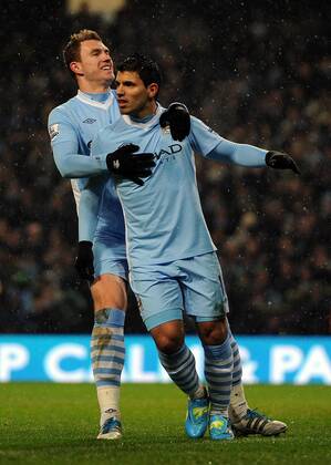 Manchester City s Sergio Kun Agüero celebrates scoring the opening goal with team-mate Edin Dzeko during the Premiership match at the Etihad Stadium. xHOCHxZWEIx xPropagandax