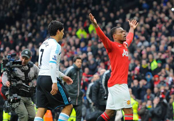 Patrice Evra of Manchester United celebrates in front of Luis Suarez of Liverpool FC at the end of the match.Barclays Premier League.Manchester United v Liverpool FC at Old Trafford, Manchester on the 11th February 2012 - - EDITORIAL USE ONLY. No use with unauthorised audio, video, data, fixture lists, club league logos or live services. Online in-match use limited to 120 images, no video emulation. No use in betting, games or single club league player publications.