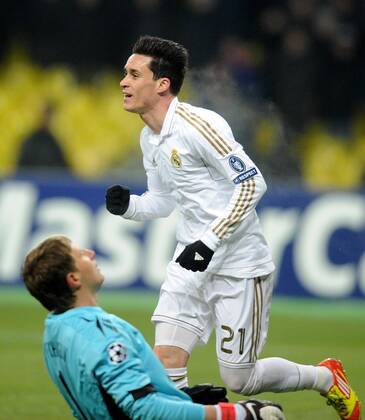 ITAR-TASS: MOSCOW, RUSSIA. FEBRUARY 21, 2012. Real s Jose Callejon (top) celebrates a goal against CSKA Moscow, as CSKA s goalkeeper Sergei Chepchugov looks dejected in their UEFA Champions League football match at Luzhniki Stadium. The game ended in a 1-1 draw.  Premiumd 122400