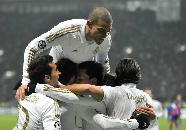 ITAR-TASS: MOSCOW, RUSSIA. FEBRUARY 21, 2012. Real s Pepe (top), Arbeloa (bottom L), Khedira (bottom R), and their teammates celebrate a goal against CSKA Moscow in their UEFA Champions League football match at Luzhniki Stadium. The game ended in a 1-1 draw.  Premiumd 122402