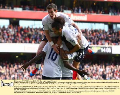 Football - Premier League - Arsenal FC London vs. Tottenham Hotspur - Tottenham s Gareth Bale and Benoit Assou-Ekotto mob Emmanuel Adebayor following his goal from the penalty spot at the Emirates Stadium