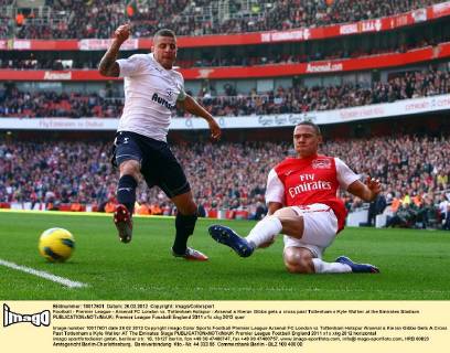 Football - Premier League - Arsenal FC London vs. Tottenham Hotspur - Arsenal s Kieran Gibbs gets a cross past Tottenham s Kyle Walker at the Emirates Stadium