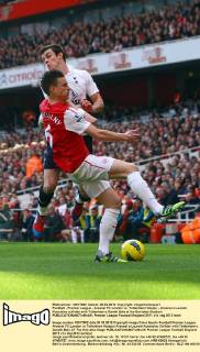 Football - Premier League - Arsenal FC London vs. Tottenham Hotspur - Arsenal s Laurent Koscielny collides with Tottenham s Gareth Bale at the Emirates Stadium