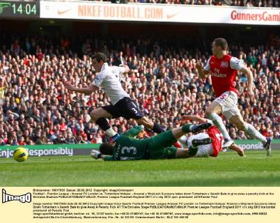 Football - Premier League - Arsenal FC London vs. Tottenham Hotspur - Arsenal s Wojciech Szczesny takes down Tottenham s Gareth Bale to give away a penalty kick at the Emirates Stadium
