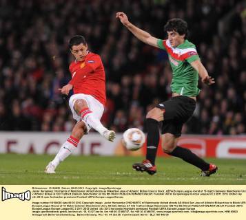 Javier Hernandez Chicharito of Manchester United shoots as Mikel San Jose of Athletic Bilbao tries to block..UEFA Europa League round of 16 match between Manchester Utd v Athletic Bilbao at Old Trafford Stadium, Manchester on the 8th March EDITORIAL USE ONLY. No use with unauthorised audio, video, data, fixture lists, club league logos or live services. Online in-match use limited to 120 images, no video emulation. No use in betting, games or single club league player publications.