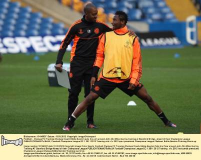 Football - Chelsea FC Training Chelsea Coach Eddie Newton puts his arm around John Obi Mikel during training at Stamford Bridge, ahead of their Champions League 