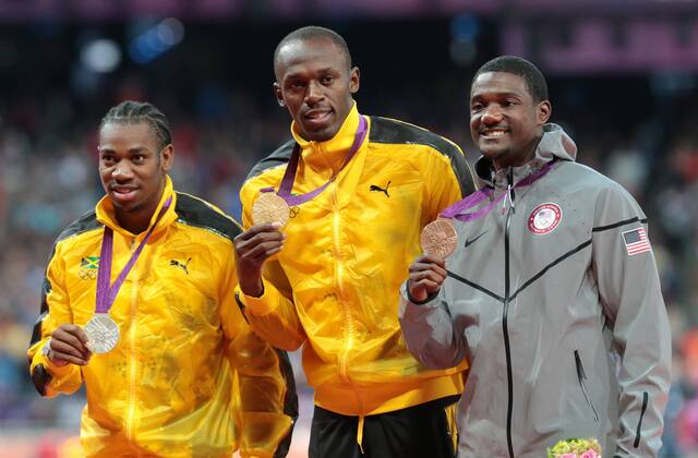 Jamaica s Yohan Blake,Usain Bolt and America s Justin Gatlin at the 100m medal ceremony in the Olympic stadium London 2012 Summer Olympics on August 6, 2012 in London.  OLY20120806631