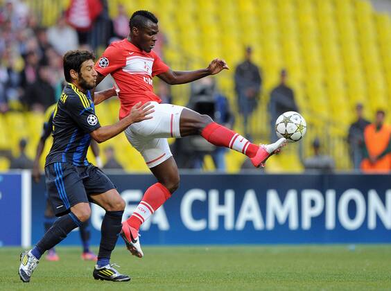 MOSCOW, RUSSIA. AUGUST 21, 2012. Spartak s Emmanuel Emenike (red) and Egemen Korkmaz of Fenerbahce in action during a UEFA Champions League group stage match Spartak (Moscow) vs. Fenerbahce S.K.  premiumd RE1065B9