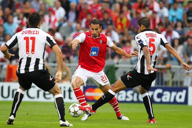 Paulo Vinicius (C) of SC Braga challenges Maurizio Domizzi (L) and Danilo Larangeira (R) of Udinese Calcio during their UEFA Champions League Play-off First Leg, SC Sporting Braga - Udinese Calcio 