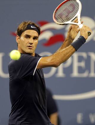 Roger Federer of Switzerland hits a backhand in the first set of his first round match at the 2012 U.S. Open Tennis Championships in Arthur Ashe Stadium at the Billie Jean King National Tennis Center in New York City on August 27, 2012.  NYP20120827131