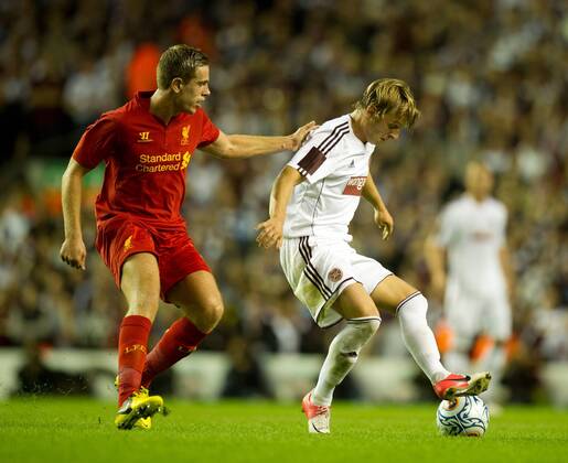 Jordan Henderson of Liverpool tussles with Atvydas Novikovas of Hearts.Europa League qualifying play off, second leg.Liverpool FC - Hearts of Midlothian at Anfield, Liverpool on the 30th August 2012.EDITORIAL USE ONLY. No use with unauthorised audio, video, data, fixture lists, club league logos or live services. Online in-match use limited to 120 images, no video emulation. No use in betting, games or single club league player publications.