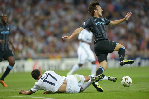 Football - Champions League - Real Madrid v Manchester City Manchester City striker David Silva is tackled by Real Madrid defender Alvaro Albeloa at Estadio Santiago Bernaeu in Madrid 