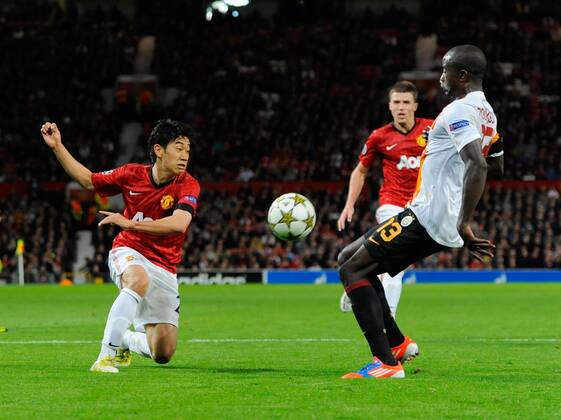 Shinji Kagawa of Manchester United challenged by Dany Nounkeu of Galatasaray Manchester United (ManU) - Galatasaray Istanbul EDITORIAL USE ONLY. No use with unauthorised audio, video, data, fixture lists, club league logos or live services. Online in-match use limited to 120 images, no video emulation. No use in betting, games or single club league player publications.
