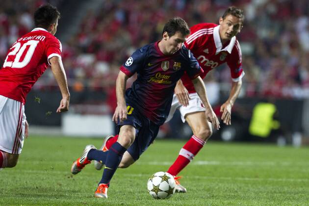 2 October 2012 - Lisbon, Portugal - Lionel Messi FC Barcelona forward passing by SL Benfica players during the UEFA Champions League soccer match between SL Benfica and FC Barcelona for group stage - group D, at SL Benfica, Luz stadium in Lisbon. 