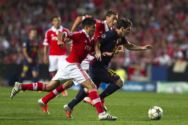 2 October 2012 - Lisbon, Portugal - Lionel Messi FC Barcelona forward passing by SL Benfica players during the UEFA Champions League soccer match between SL Benfica and FC Barcelona for group stage - group D, at SL Benfica, Luz stadium in Lisbon. 