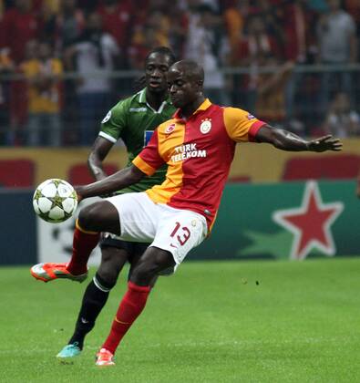 Dany Nounkeu (R) of Galatasaray is challanged for the ball with Leaandro Salino (L) of SC Sporting Braga during UEFA Champions League Group H matcah between Galatasaray and SC Sporting Braga played at Turk Telekom Arena Ali Sami Yen Sports Complex in Istanbul. Turkey 02.10.2012 