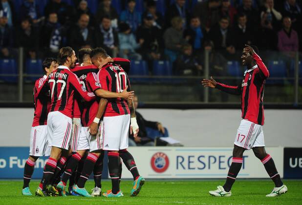 ITAR-TASS: ST PETERSBURG, RUSSIA. OCTOBER 3, 2012. Milan players celebrate a goal against Zenit in their UEFA Champions League Group C football match at Petrovsky Stadium. A.C. Milan won the game 2-3.  RE109E40