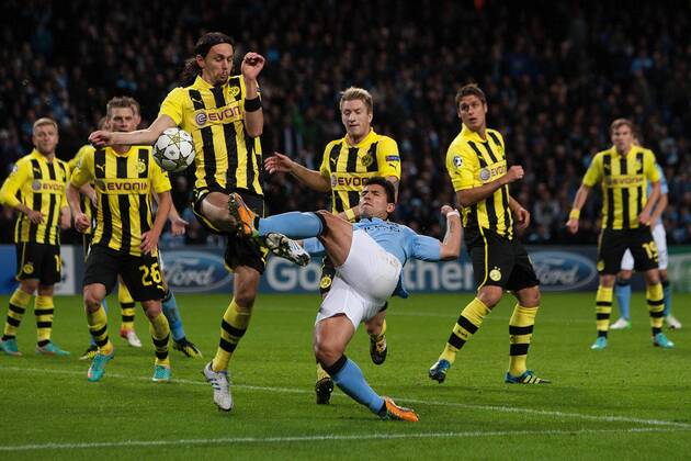 Football - Champions League - Manchester City vs. Borussia Dortmund Neven Subotic of Dortmund is judged to have hand balled and concedes a penalty at the Etihad Stadium 