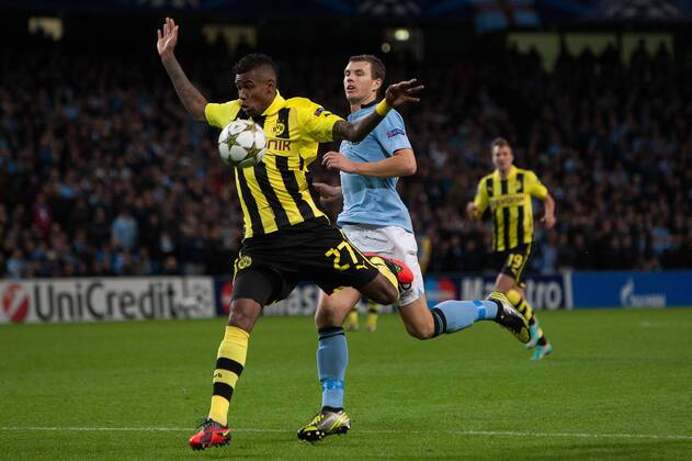 Football - Champions League - Manchester City vs. Borussia Dortmund Felipe Santana of Dortmund defends against Edin Dzeko of Manchester City at the Etihad Stadium 