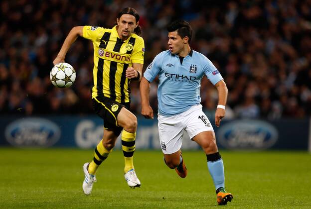 Manchester City s Sergio Aguero (R) in action with Borussia Dortmund s Neven Subotic..Champions League football match between Manchester City and Borussia Dortmund at the Etihad Stadium, Manchester on the 3rd October 2012 EDITORIAL USE ONLY. No use with unauthorised audio, video, data, fixture lists, club league logos or live services. Online in-match use limited to 120 images, no video emulation. No use in betting, games or single club league player publications.