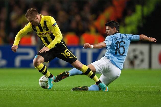 Football - Champions League - Manchester City vs. Borussia Dortmund Sergio Aguero of Manchester City challenges Jakub Kuba Blaszczykowski of Dortmund at the Etihad Stadium 