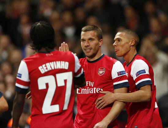 Arsenal s Lukas Podolski celebrates scoring his sides second goal..Football - Champions League Matchday 2 - Emirates Stadium, London - 3 10 12EDITORIAL USE ONLY. EDITORIAL USE ONLY. No use with unauthorised audio, video, data, fixture lists, club league logos or live services. Online in-match use limited to 120 images, no video emulation. No use in betting, games or single club league player publications.