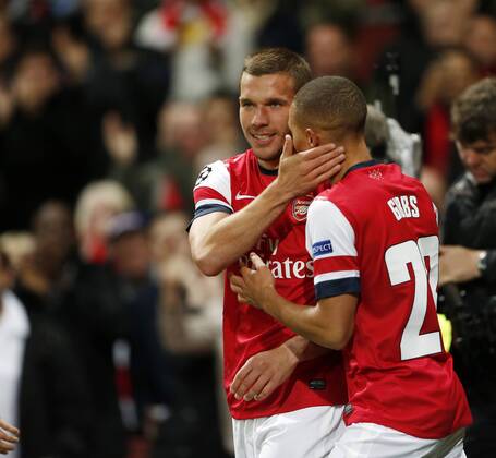 Arsenal s Lukas Podolski celebrates scoring his sides second goal..Football - Champions League Matchday 2 - Emirates Stadium, London - 3 10 12EDITORIAL USE ONLY. EDITORIAL USE ONLY. No use with unauthorised audio, video, data, fixture lists, club league logos or live services. Online in-match use limited to 120 images, no video emulation. No use in betting, games or single club league player publications.