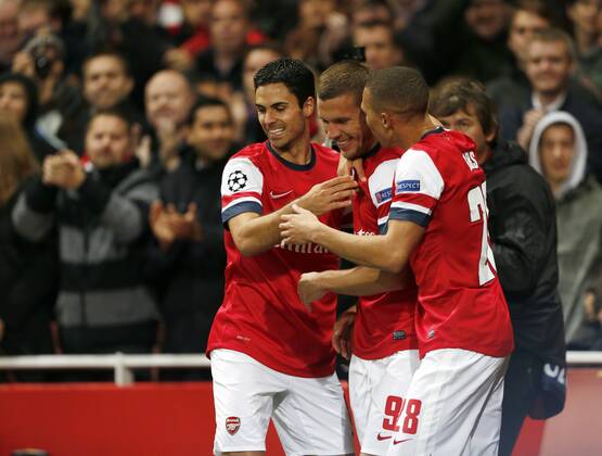 Arsenal s Lukas Podolski celebrates scoring his sides second goal..Football - Champions League Matchday 2 - Emirates Stadium, London - 3 10 12EDITORIAL USE ONLY. EDITORIAL USE ONLY. No use with unauthorised audio, video, data, fixture lists, club league logos or live services. Online in-match use limited to 120 images, no video emulation. No use in betting, games or single club league player publications.