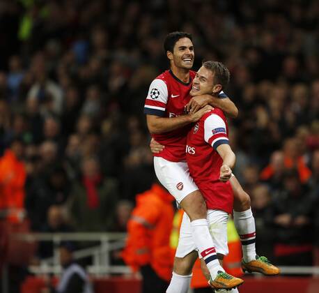 Arsenal s Aaron Ramsey celebrates scoring his sides third goal..Football - Champions League Matchday 2 - Emirates Stadium, London - 3 10 12EDITORIAL USE ONLY. EDITORIAL USE ONLY. No use with unauthorised audio, video, data, fixture lists, club league logos or live services. Online in-match use limited to 120 images, no video emulation. No use in betting, games or single club league player publications.