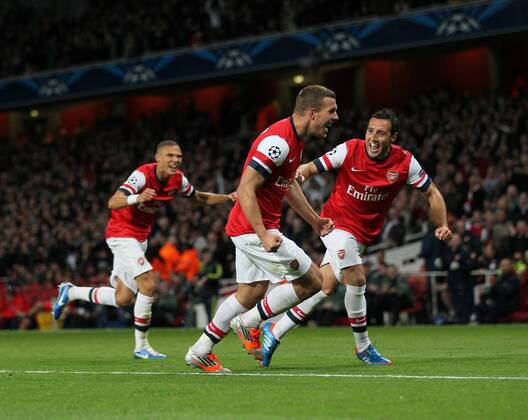 Arsenal s Lukas Podolski celebrates scoring his sides second goal..Football - Champions League Matchday 2 - Emirates Stadium, London - 3 10 12EDITORIAL USE ONLY.... EDITORIAL USE ONLY. No use with unauthorised audio, video, data, fixture lists, club league logos or live services. Online in-match use limited to 120 images, no video emulation. No use in betting, games or single club league player publications.