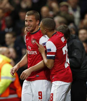 Arsenal s Lukas Podolski celebrates scoring his sides second goal..Football - Champions League Matchday 2 - Emirates Stadium, London - 3 10 12EDITORIAL USE ONLY. EDITORIAL USE ONLY. No use with unauthorised audio, video, data, fixture lists, club league logos or live services. Online in-match use limited to 120 images, no video emulation. No use in betting, games or single club league player publications.
