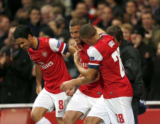 Arsenal s Lukas Podolski celebrates scoring his sides second goal..Football - Champions League Matchday 2 - Emirates Stadium, London - 3 10 12EDITORIAL USE ONLY. EDITORIAL USE ONLY. No use with unauthorised audio, video, data, fixture lists, club league logos or live services. Online in-match use limited to 120 images, no video emulation. No use in betting, games or single club league player publications.